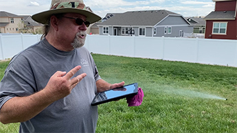 Man talks with green grass in the background