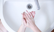 hand washing over a white sink